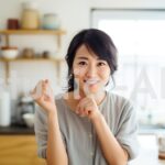 キッチンで自信なさそうに手を挙げる女性